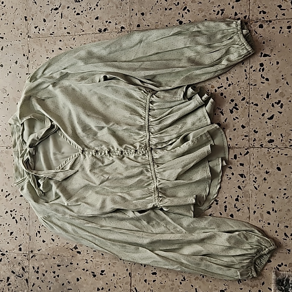 A green silky polka dot blouse